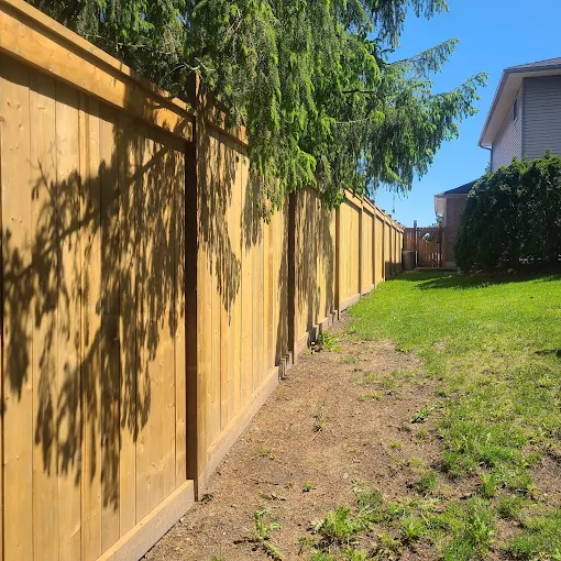 New cedar board privacy fence installed along a Durham Region backyard