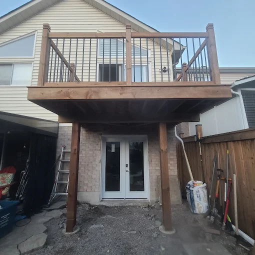 Raised second-storey deck with aluminum railings and timber posts