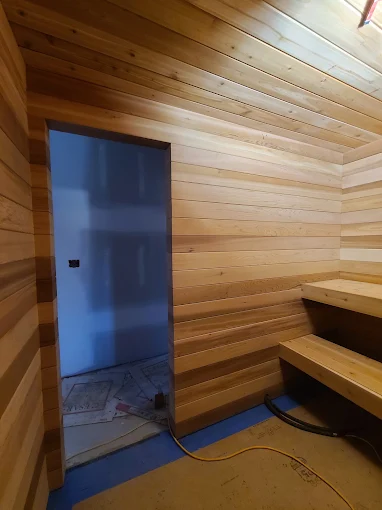 Cedar-lined sauna build with bench seating in a Durham Region home