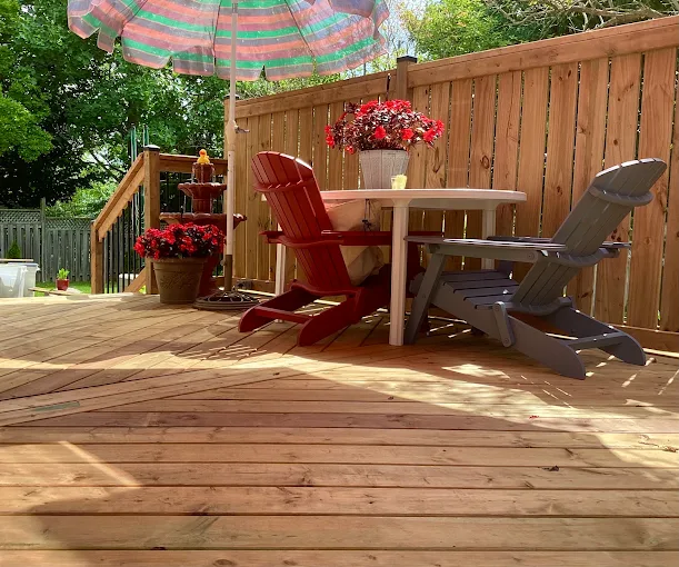 Finished cedar deck with privacy fence and outdoor seating in Oshawa