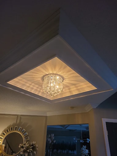 Tray ceiling with crown moulding and chandelier in a Durham Region home